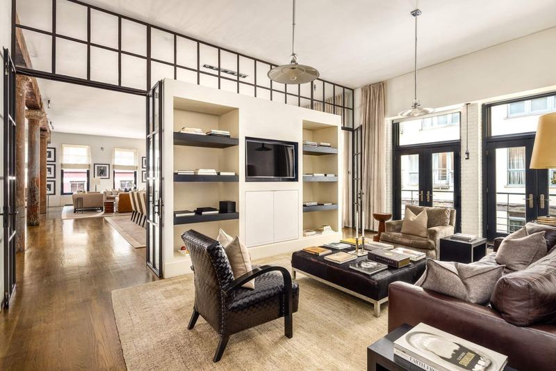 The library/media room, with built-in shelving and French doors at 42 Wooster Street #3, SoHo — photo 6 of 13