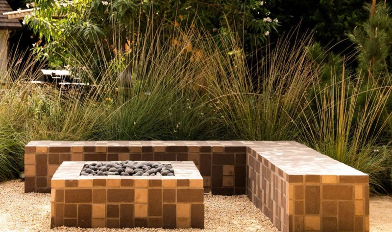 tiled fire pit and ornamental grasses in the garden at 4343 Forman Avenue