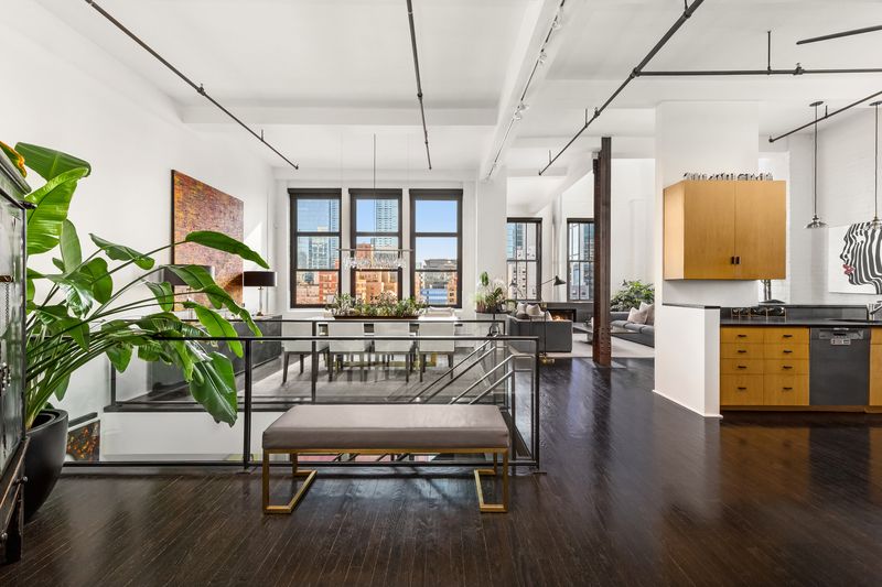 Double-height living room with a wood-burning fireplace at The Glass Farmhouse, 448 West 37th Street 11G/12G, Hudson Yards