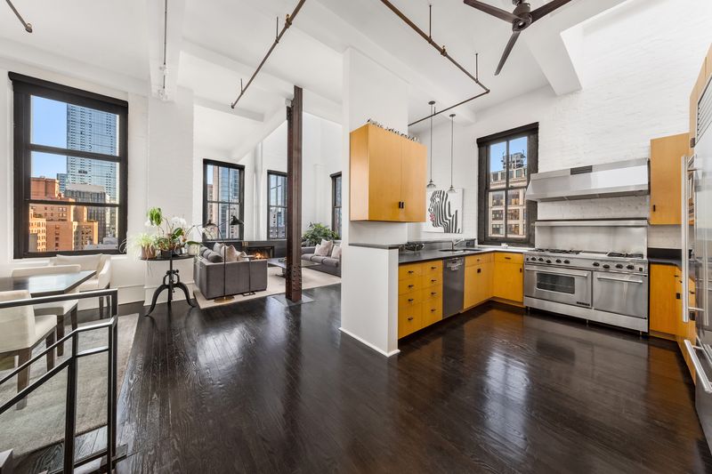 Open loft looking toward the kitchen and dining area at The Glass Farmhouse, 448 West 37th Street 11G/12G, Hudson Yards — photo 2 of 10