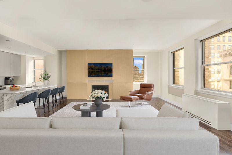 Open living room toward kitchen island and fireplace wall at 450 Washington Street 520, Tribeca — photo 2 of 7