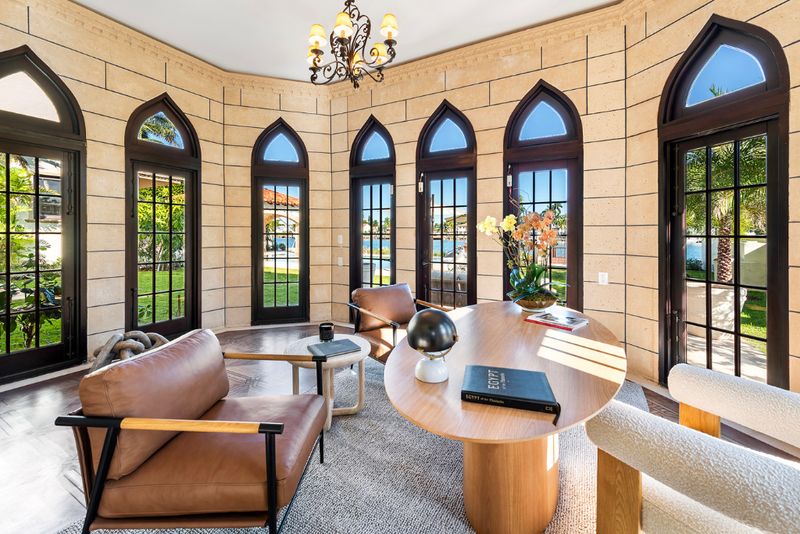 Stone sitting room with Gothic windows at 49 Palm Avenue, Palm Island, Miami Beach — photo 3 of 5