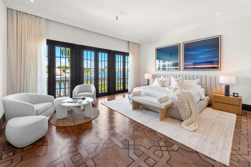 Bedroom with French doors to the water at 49 Palm Avenue, Palm Island, Miami Beach — photo 5 of 5