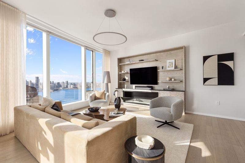 Living area media wall at 50 West Street 37C, Financial District — photo 4 of 9