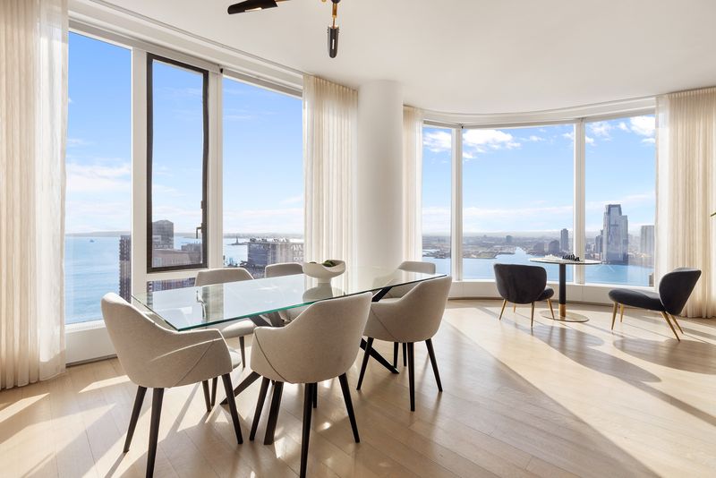 Dining area harbor views at 50 West Street 37C, Financial District — photo 5 of 9