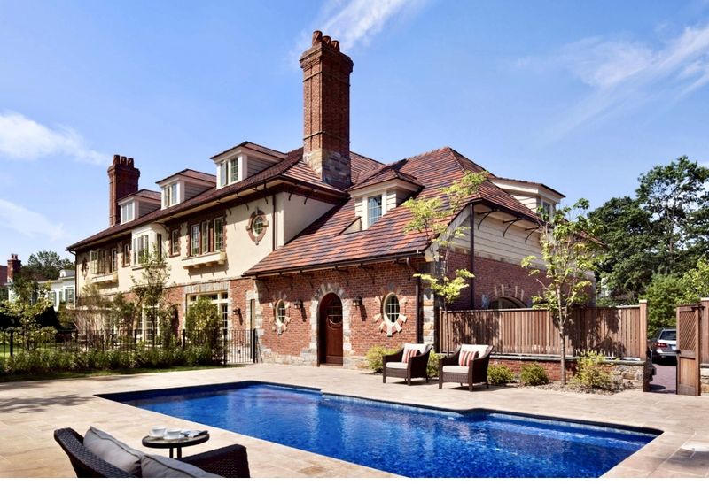 Rear of the house with the in-ground pool and terrace at 5020 Iselin Avenue, Riverdale