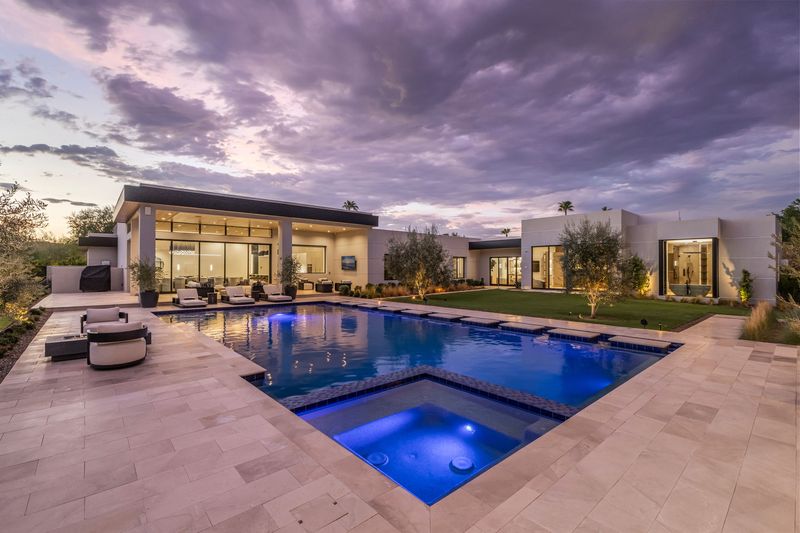 Pool and spa at dusk at 5441 E Via Buena Vista, Paradise Valley