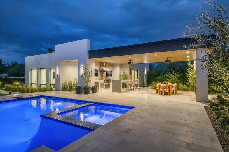 Outdoor kitchen terrace dusk at 5441 E Via Buena Vista, Paradise Valley — photo 3 of 10