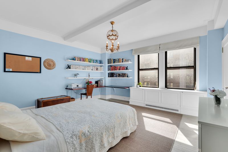 Bedroom with light blue walls and built-ins at 55 East 86th Street 8B, Carnegie Hill — photo 4 of 9