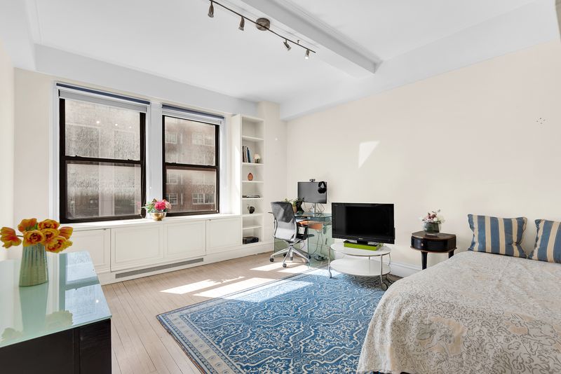 Bedroom with city windows at 55 East 86th Street 8B, Carnegie Hill — photo 6 of 9