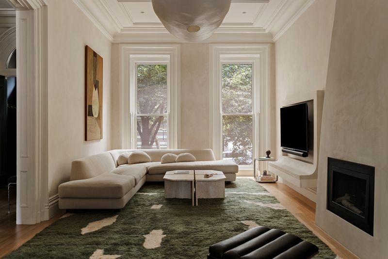 The parlor, anchored by a curved limewashed fireplace at 59 Lefferts Place, Clinton Hill — photo 2 of 10