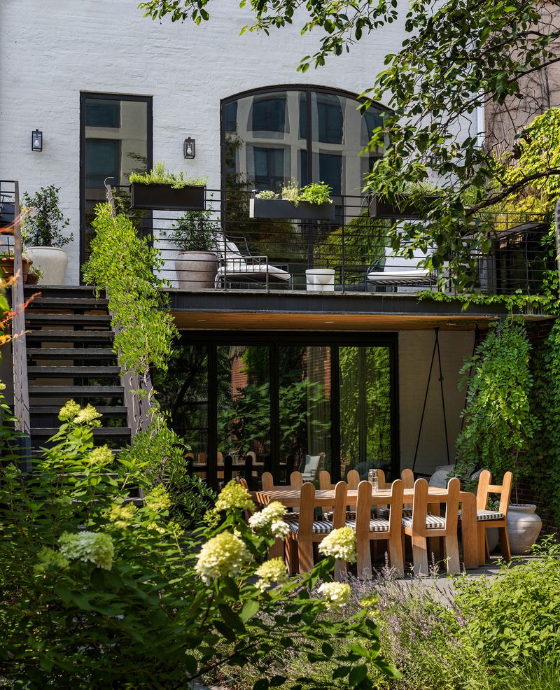 Rear facade and the planted garden with outdoor dining at 59 Lefferts Place, Clinton Hill — photo 4 of 10