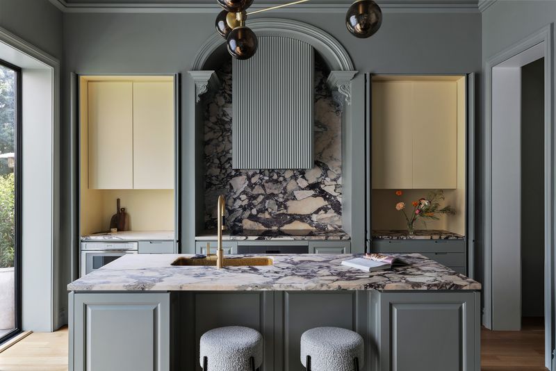 Kitchen with a marble island and brass fittings at 59 Lefferts Place, Clinton Hill — photo 5 of 10