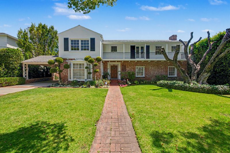 Brick-and-clapboard Traditional facade behind a deep front lawn at 608 Trenton Drive, Beverly Hills Flats