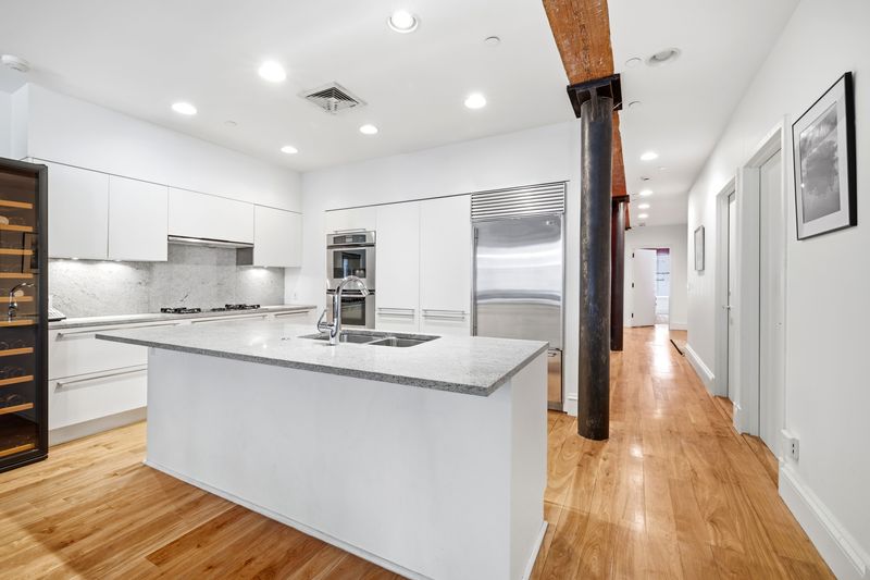 Open kitchen with island at 61 North Moore Street 3W, Tribeca — photo 3 of 5