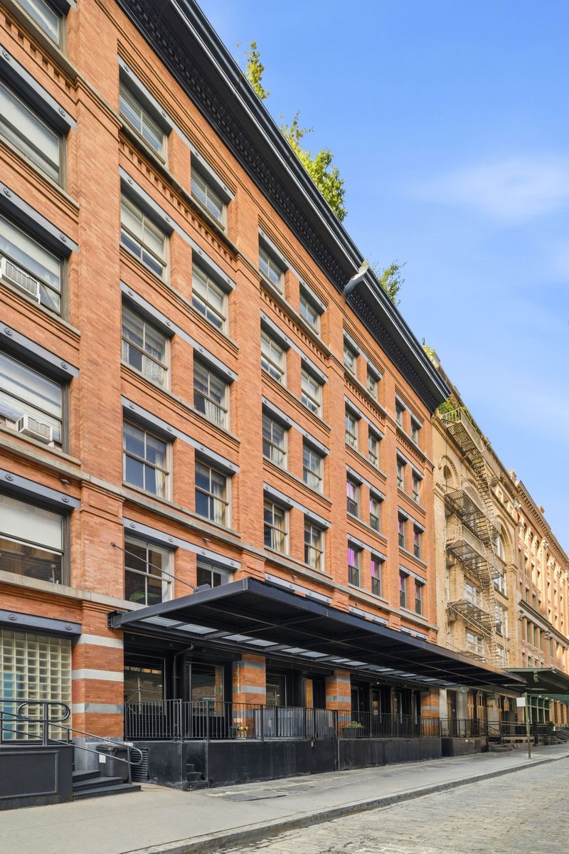 Exterior brick facade on the cobblestone street at 61 North Moore Street 3W, Tribeca — photo 5 of 5