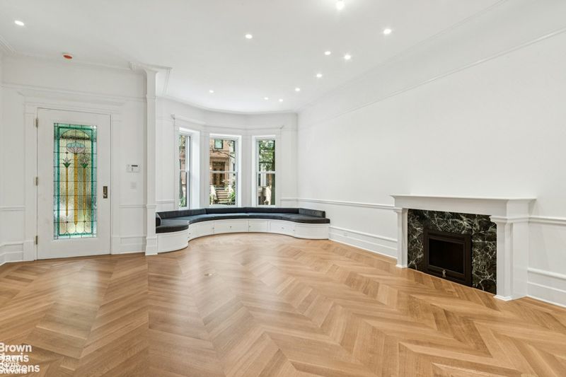 Living room with fireplace and stained-glass door at 611 2nd Street, Park Slope — photo 3 of 10