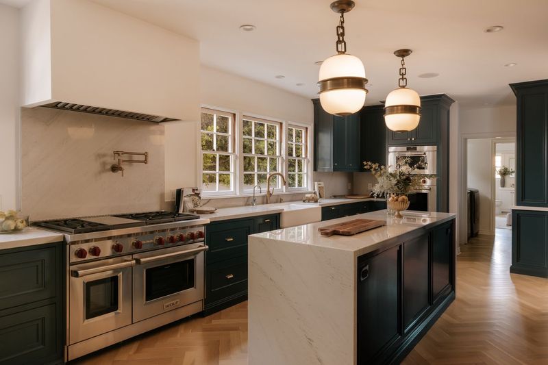 The kitchen, with a stone-clad island and a Wolf double-oven range at 628 North Sierra Drive, Beverly Hills — photo 4 of 8