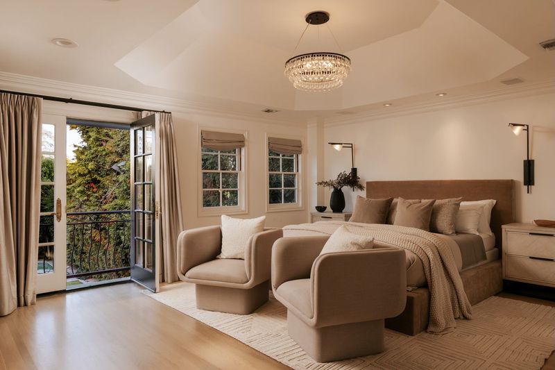 The primary suite, with a sitting area and doors to a balcony at 628 North Sierra Drive, Beverly Hills — photo 7 of 8