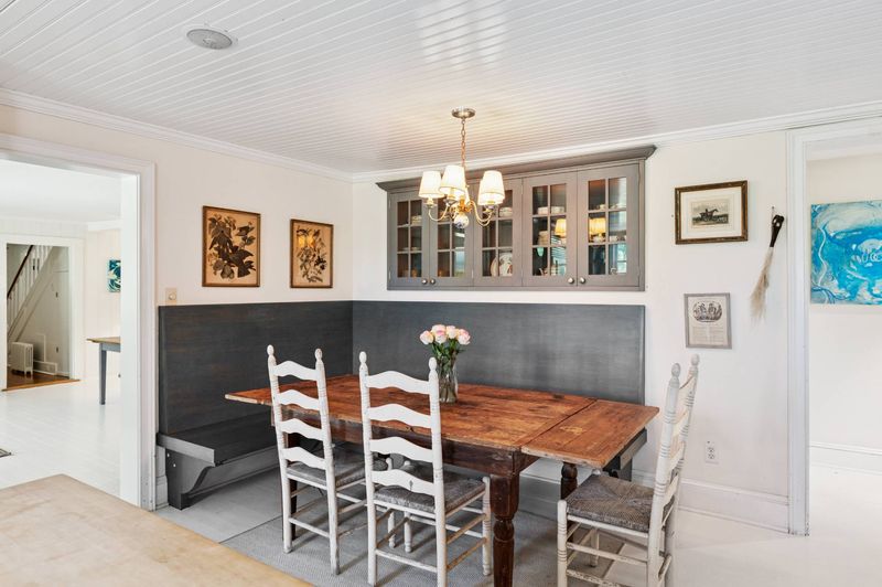 Breakfast nook with banquette and farmhouse table at 645 North Sea Mecox Road, Southampton — photo 8 of 12