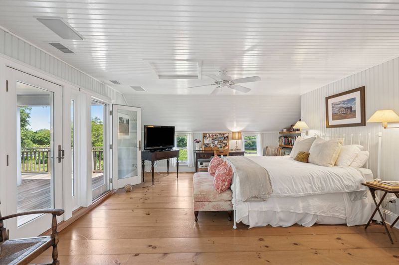 Primary bedroom opening to the upper terrace at 645 North Sea Mecox Road, Southampton — photo 10 of 12