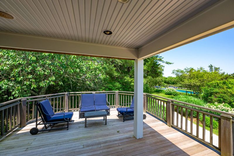 Upper terrace seating above the pool gardens at 645 North Sea Mecox Road, Southampton — photo 11 of 12