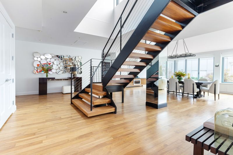 Double-height living area with steel staircase at 655 Sixth Avenue PHB, Chelsea — photo 4 of 8