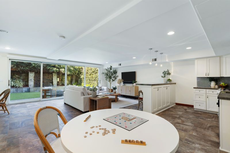 Lower level opening to the backyard lawn at 721 12th Street, Manhattan Beach — photo 3 of 8