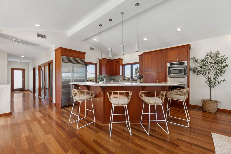 Kitchen with wood cabinetry and island at 721 12th Street, Manhattan Beach — photo 6 of 8