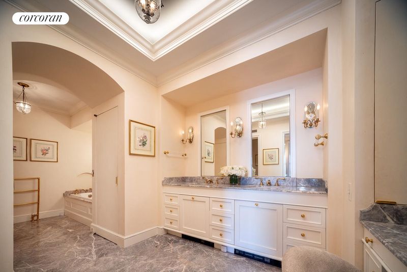 Primary bath with two sinks at 740 Park Avenue 6/7D, Lenox Hill — photo 9 of 12