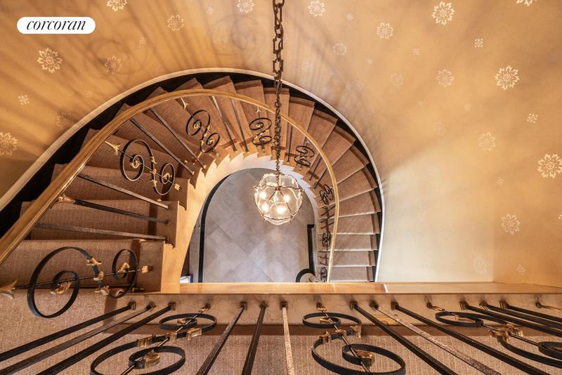 Looking down the curved staircase at 740 Park Avenue 6/7D, Lenox Hill — photo 11 of 12