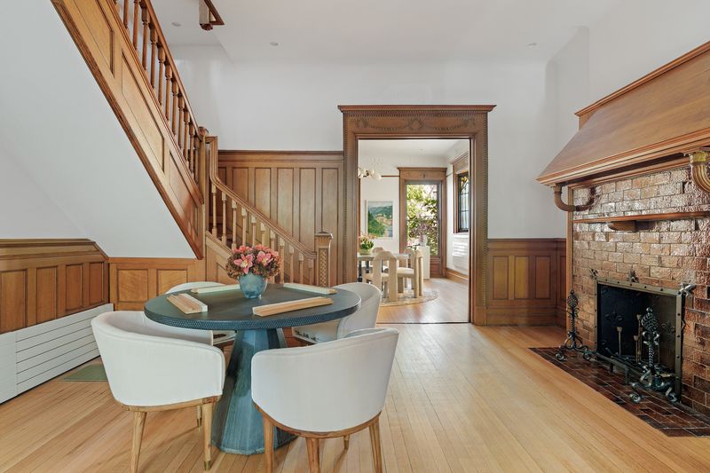 Stair hall and dining with brick fireplace at 8 Polhemus Place, Park Slope — photo 3 of 12