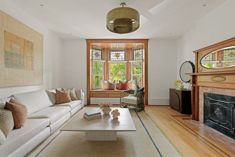 Den with fireplace and bay window at 8 Polhemus Place, Park Slope — photo 6 of 12