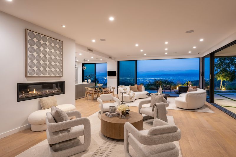 Living room with linear fireplace and wall of glass at 8545 Charl Lane, Hollywood Hills — photo 4 of 8