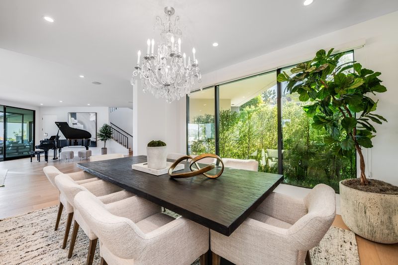 Dining room under a crystal chandelier at 8545 Charl Lane, Hollywood Hills — photo 6 of 8
