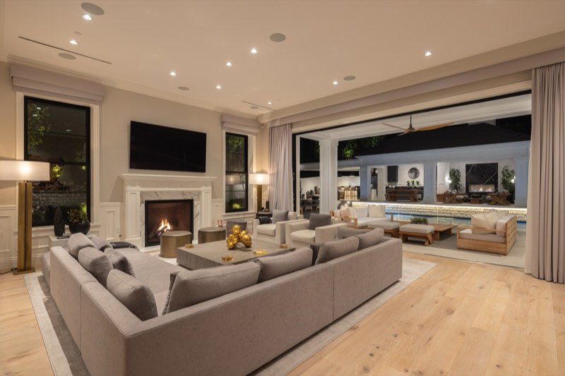 family room opening to the pool at dusk at 9520 Hidden Valley Road