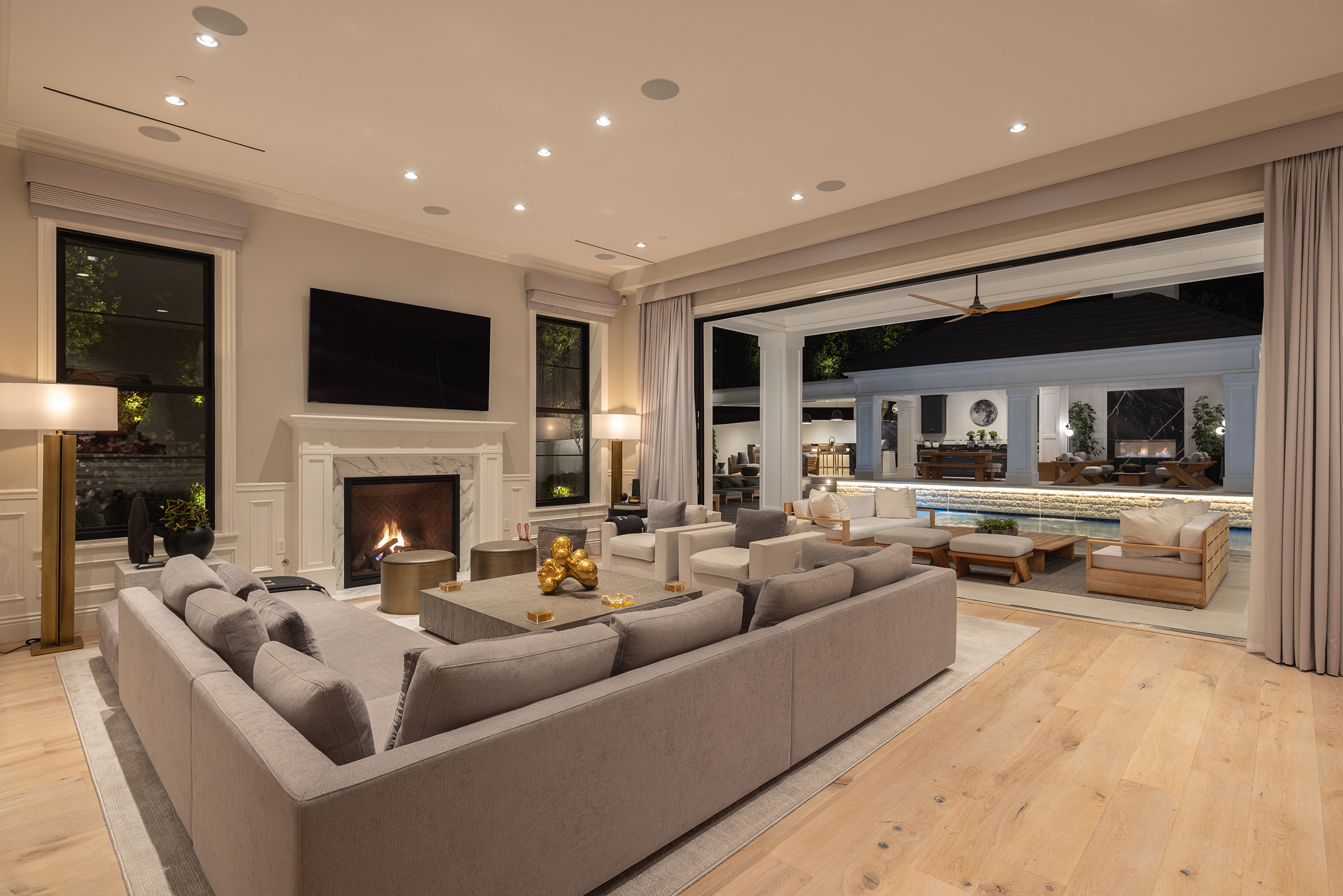 family room opening to the pool at dusk at 9520 Hidden Valley Road