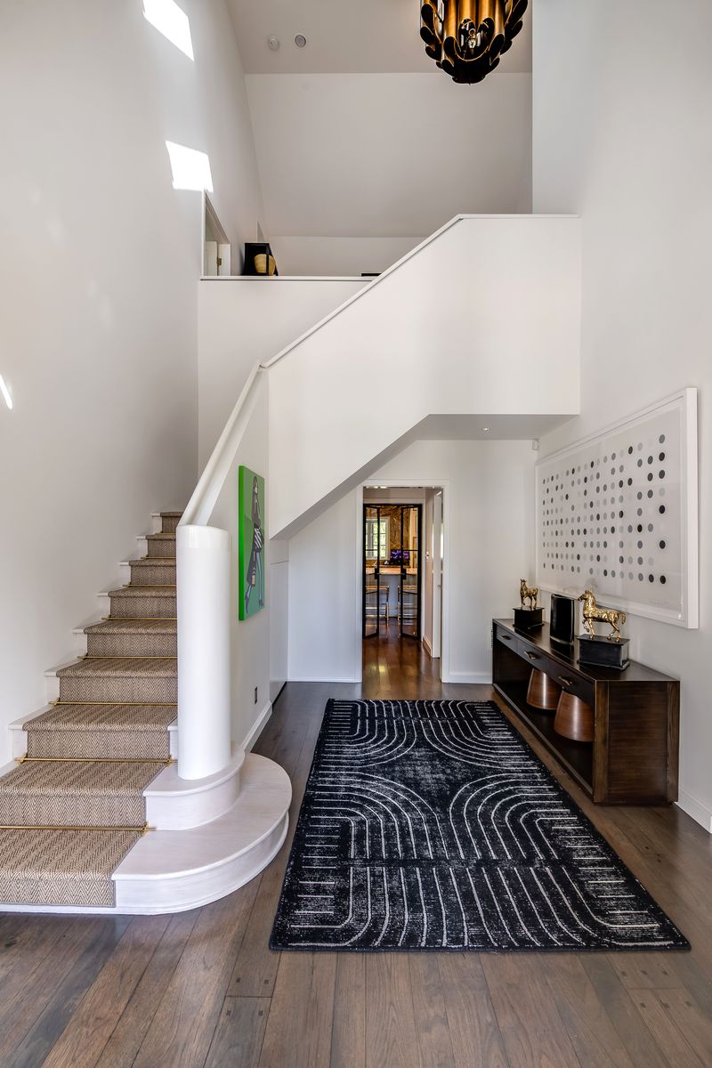 Stair hall with neutral runner at 9551 Lime Orchard Road, Beverly Hills — photo 4 of 8