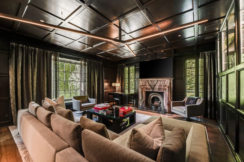 Wood-paneled study with stone fireplace at 9551 Lime Orchard Road, Beverly Hills — photo 5 of 8
