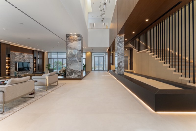 double-height foyer / marble piers / walnut stair