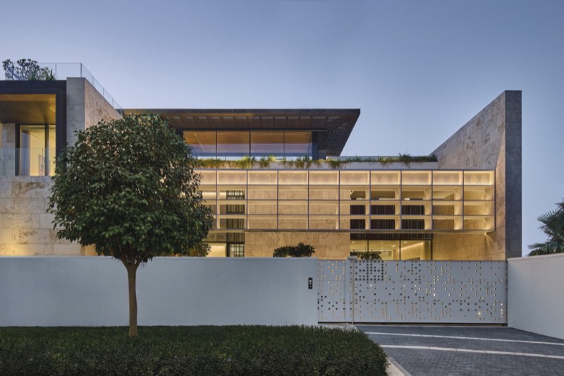 street elevation, perforated gate, blue-hour glow